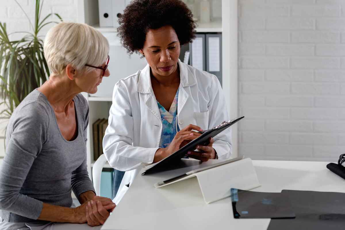 Doctor speaks with her patient about breast cancer surgery