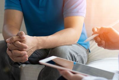 A patient talks with a physician