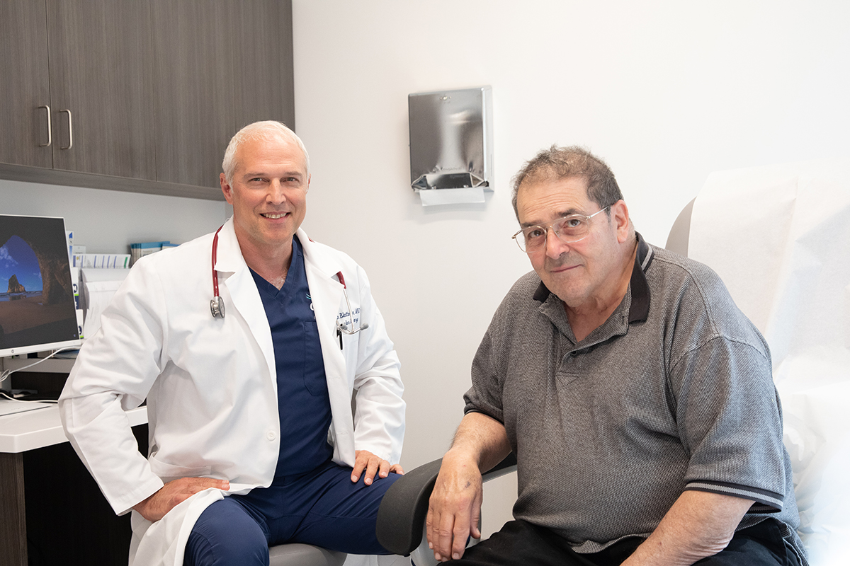 Physician and patient seated in exam room. 