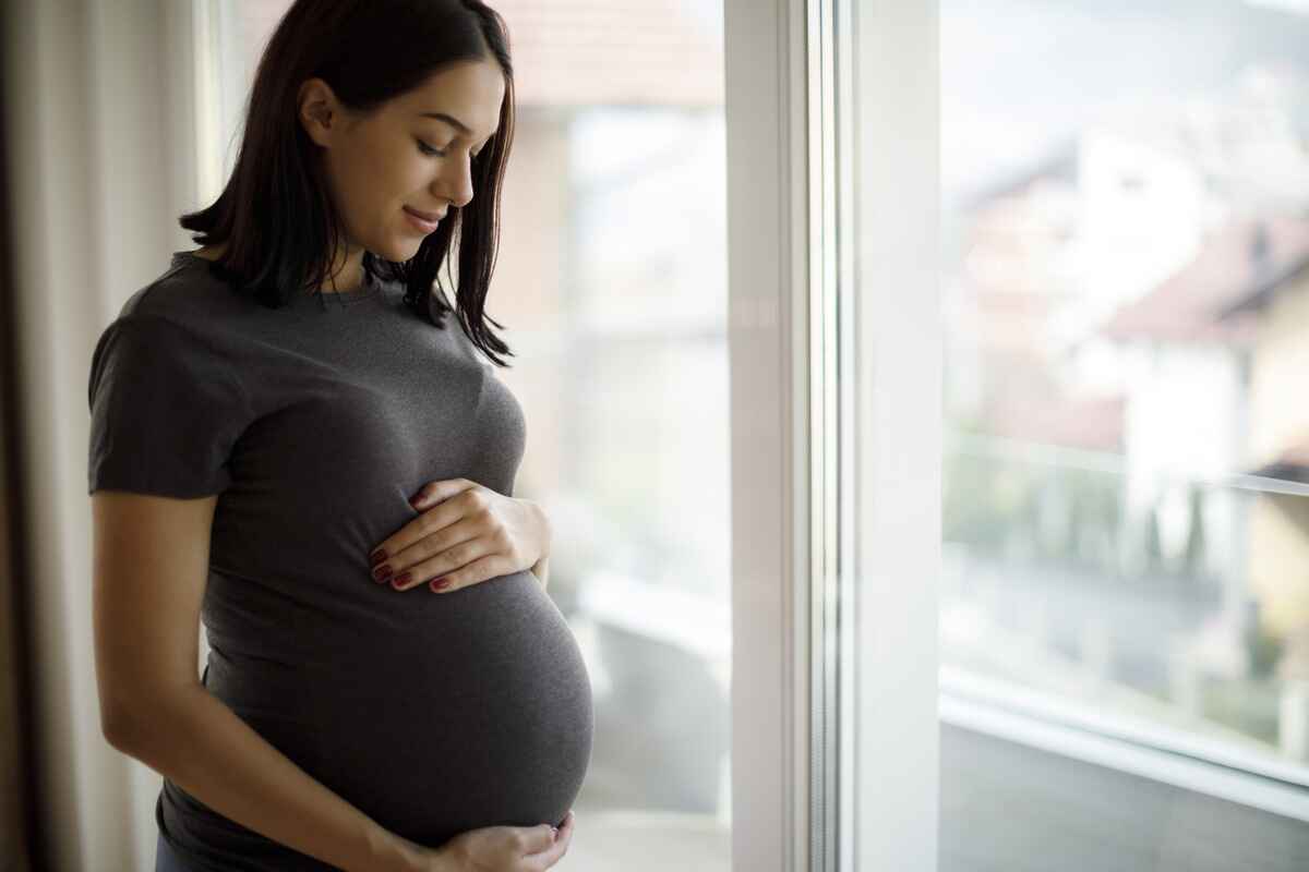 pregnant woman holds her belly