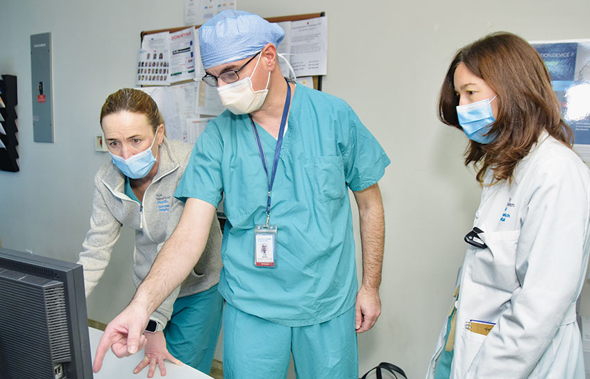 Ilir Maraj, MD, reviews a patient's test results with (left) Kelly Kulas, RN, and Rose McElwain, RN