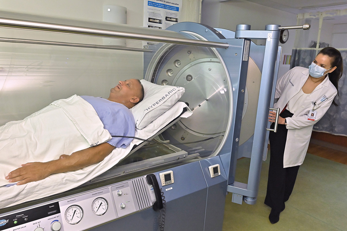 Sandra Wainwright, MD, closes the hyperbaric chamber