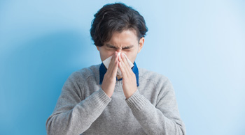 person blowing nose