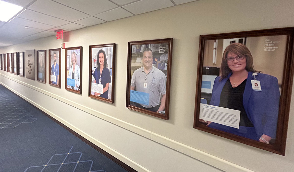 Framed photos of all 12 employees, who were chosen at random